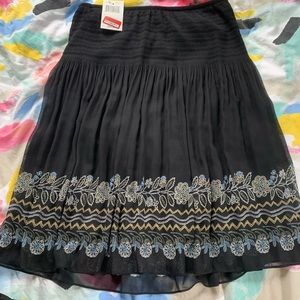 black skirt with floral pattern on the bottom